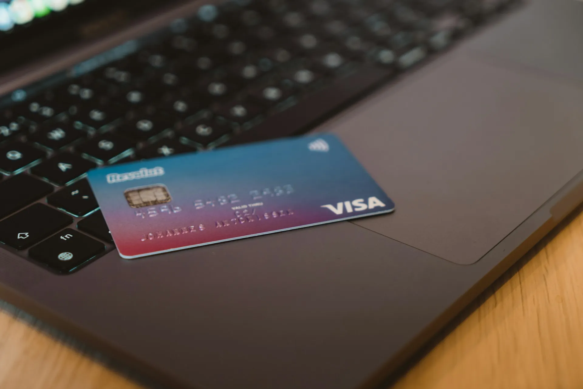 Debit card on a dark laptop